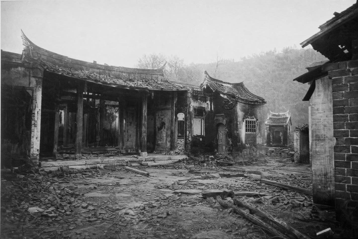 Black-and-white photograph of Master Lee's family ancestral compound after wartime damage